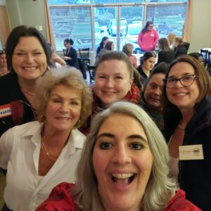 Women from WID New England Shoreline pose for a photo together